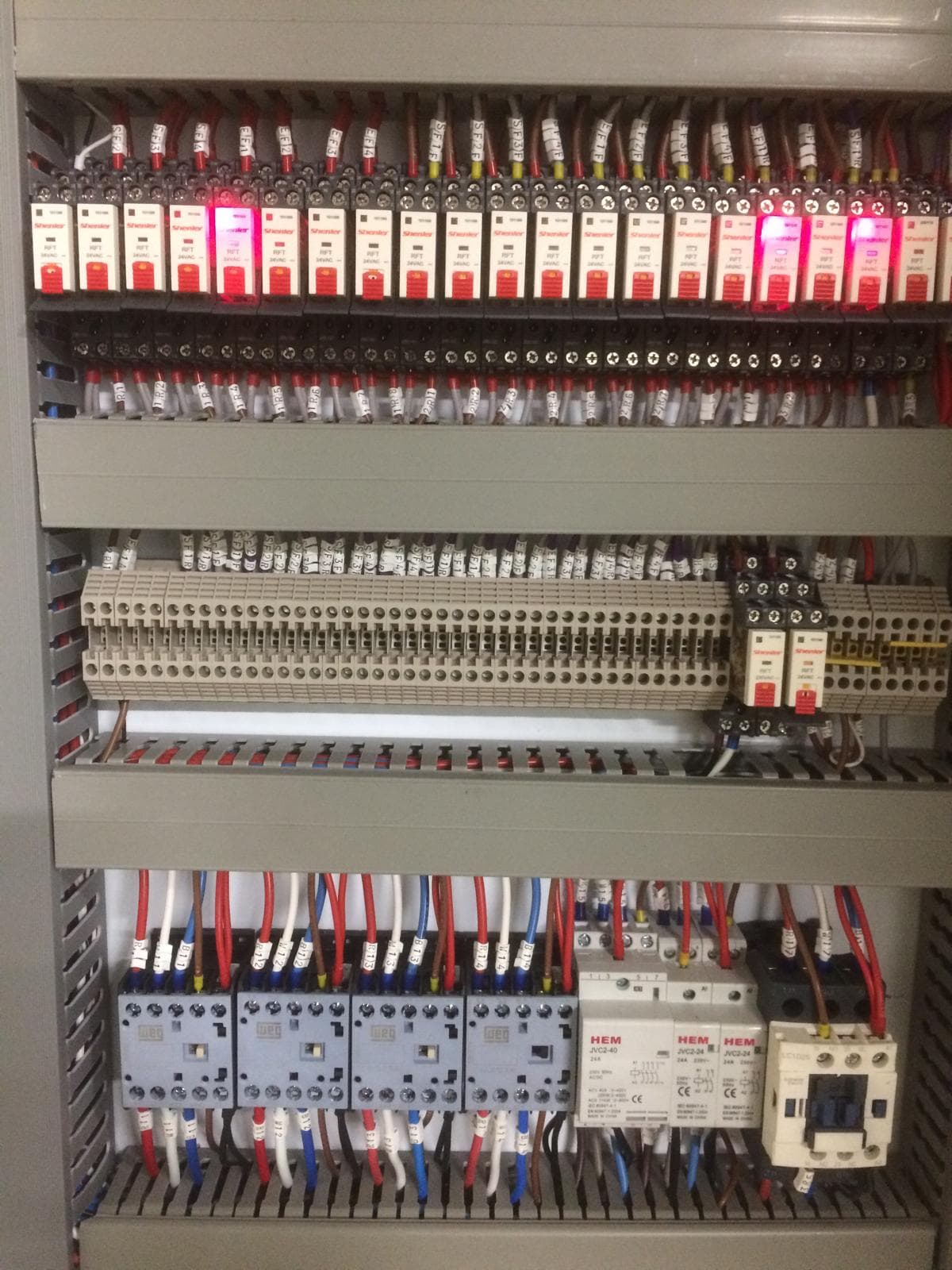 Close-up of labelled relay and terminal wiring inside an electrical panel